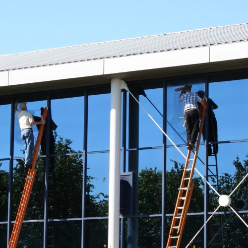 753733 - two window cleaners at work on office building